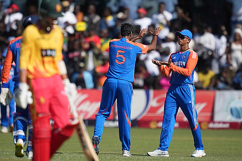 Indian players celebrate a wicket against Zimbabwe 